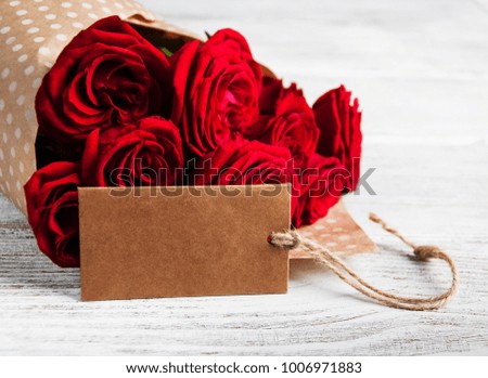 Red roses on a old wooden background