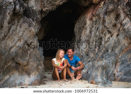 a loving couple hugs against a rock background