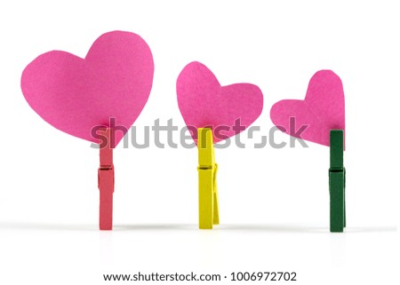 Pink Paper heart with paper clip, Valentine's day, symbol of love on white background.
