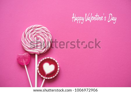 Pink Valentine's day heart shape lollipop candy on empty pink paper background. Happy Valentine's Day greeting card. Royalty-Free Stock Photo #1006972906