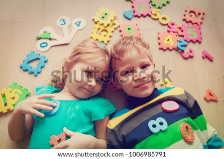 happy little girl and boy learn numbers and shapes