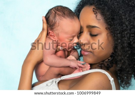 Loving african mother holding her 11 days old newborn baby Royalty-Free Stock Photo #1006999849
