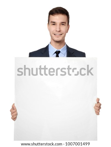 Handsome businessman with blank advertising board on white background