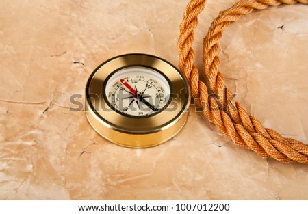 compass and rope on old paper background