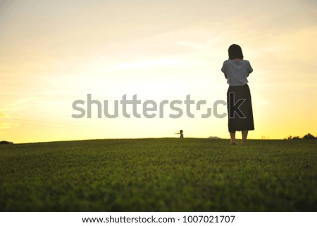 Girl Take a Photo of People in The Green Field