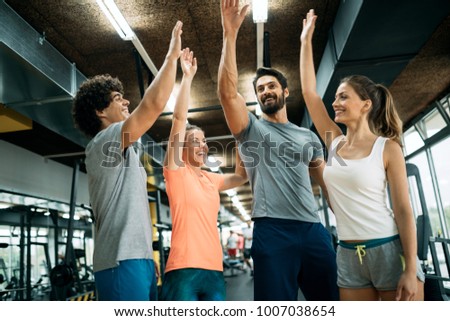 Picture of cheerful fitness team in gym