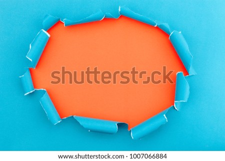 Blue ripped open paper background,space for your message on torn paper.