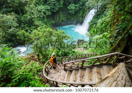 Majestic waterfall in the rainforest jungle of Costa Rica. Tropical hike. Royalty-Free Stock Photo #1007072176