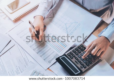 businessman using calculator for calculate budget. concept finance and accounting Royalty-Free Stock Photo #1007083714