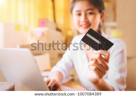 Young asian entrepreneurs women hands holding credit card for online shopping at home,teenager owner business,success and online shopping concept. 