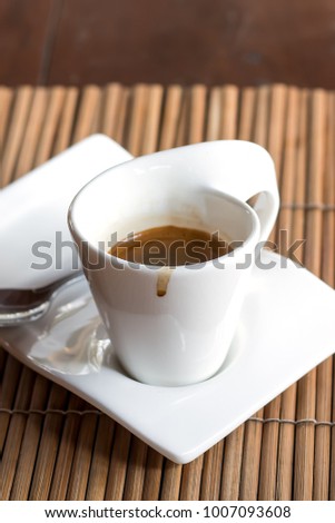 A cup of hot espresso coffee on wooden dinner table background with copy space.