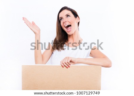 A beautiful young woman standing with a wooden box signboard and feeling happy