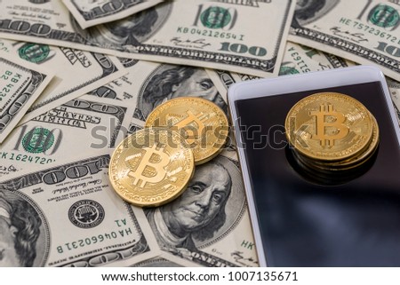 Bitcoin, smartphone on dollar bills
