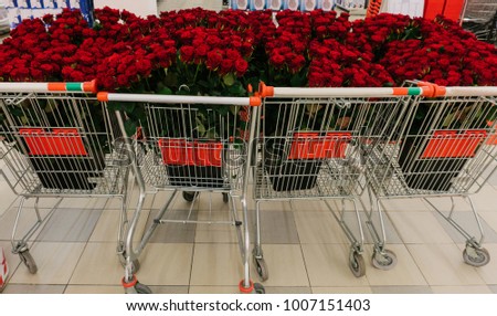 A shopping cart full with roses - Valentine's day and love concept