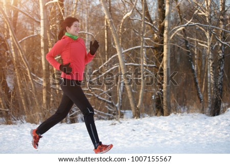 Image of brunette in sports uniform on morning run in winter