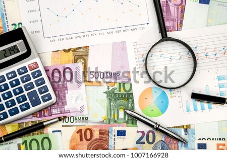 calculator pen and graph on the euro background