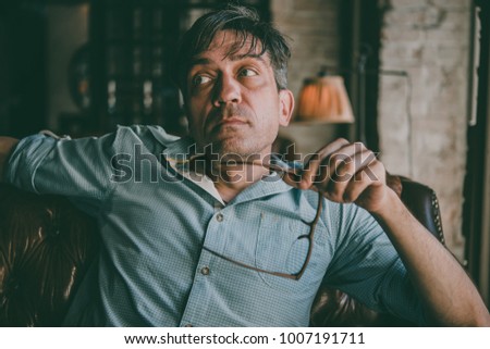 Portrait of a mature confident handsome man while thinking. Toned picture