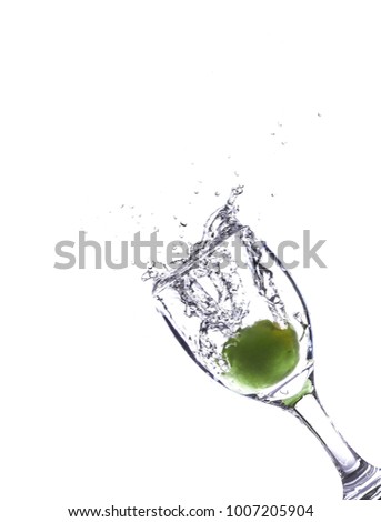 Fruit in a glass with water splash on white background