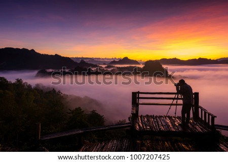 Silhouette Photographer at Baan JABO viewpoint, Mae Hong Son, Landscape mountain and sunrise with mist.