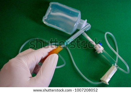 The nurse prepares the device for the saline solution. For clean and prevent infection, they always wear gloves.