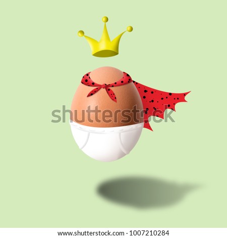Funny egg in underpants and crown on green background.