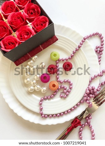 valentines table set up with decor and box of roses on the table 