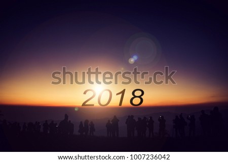 silhouette group of people standing looking sunrise in morning on 2018, concept as celebration and happy new years,copy space.
