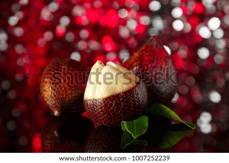 snake fruit on a festive background with bokeh. beautiful edible exotic fruits. food for vegans