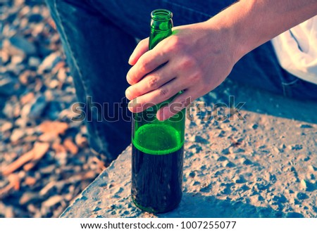 Toned Photo of Person with the Bottle of a Beer outdoor