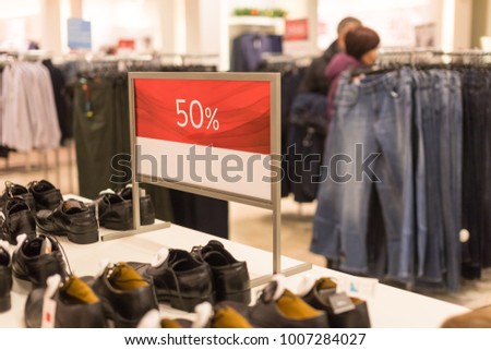 discount sign on clothing store. Sticker sign.Sale up to 50 percent on store with clothes during winter, spring sale season.Sale sign in men clothes shop.shopping and discount concept. Selective focus