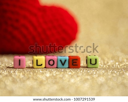 Red yarn heart with I Love You text from bead colorful on the gold floor and background copy space for text. Valentines day, love concept and love background