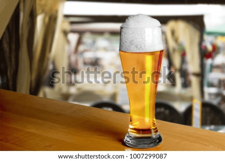 Glass of light beer on the desk