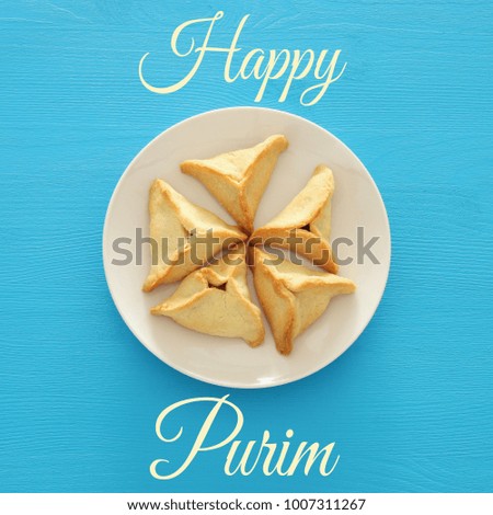 Purim celebration concept (jewish carnival holiday). Traditional hamantaschen cookies. Top view