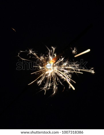 happy holidays.Vintage flim grain Style. Abstract blur  background,woman hand holding a burning sparkler light with purple sky background.closeup in female hand in dark.
