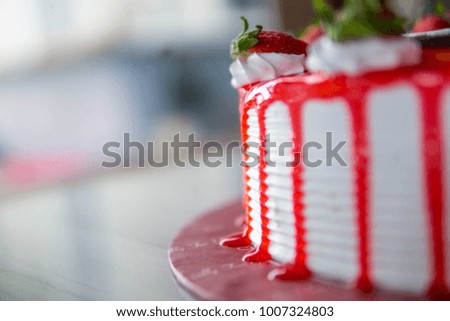 cake with strawberries and cream cheese over blurry background.selective focus