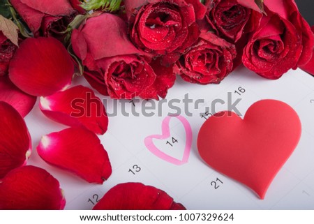 Calendar on February 14 of Saint Valentines day.Valentine's card with Red roses and red heart on the calendar date of February 14, Valentine's day. 