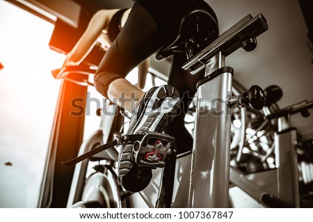 Fitness woman working out on exercise bike at the gym.exercising concept.fitness and healthy lifestyle  Royalty-Free Stock Photo #1007367847