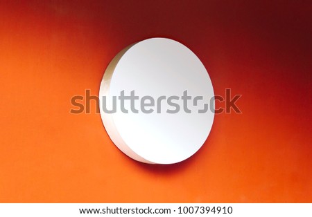 Photo of circle empty signboard isolated on orange background. Template isolated on orange background. For graphic designers presentations and portfolios white round mock-up with sign.