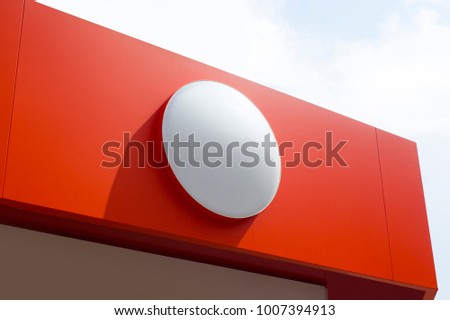 Photo of circle empty signboard isolated on red background. Template isolated on red background. For graphic designers presentations and portfolios white round mock-up with new sign.