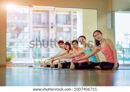 Yoga group practice performing in class together, happy and enjoy asian group