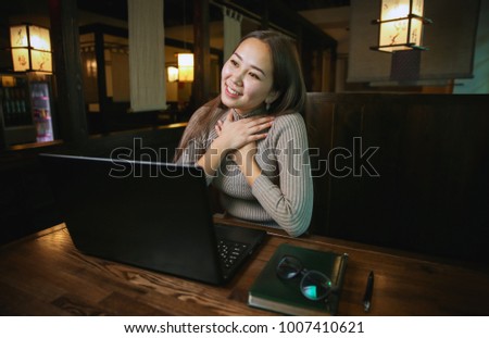 Chinese girl writes an email to his friend. and experiencing the joy of receiving the response. emotions, Notepad, glasses