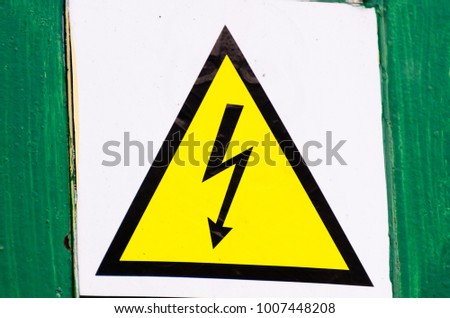 High voltage attention sign, do not touch. Black lightning on a yellow background in a triangle.
