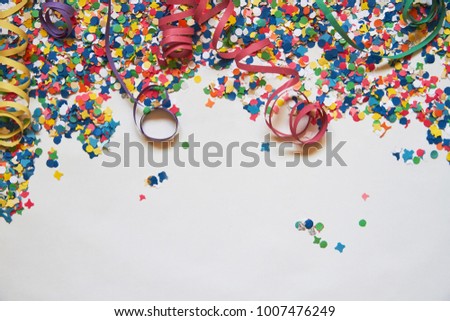 confetti and serpentine on a white background. Carnival. Abstract frame for text. holiday, birthday, anniversary, greeting card Royalty-Free Stock Photo #1007476249