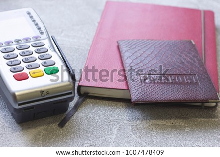 Business Wokplace, Analysis, Payment Concept with EDC machine or credit card terminal, a dayplanner and a passport, grey concrete background