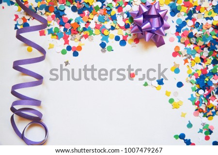 confetti and serpentine on a white background. Carnival. Abstract frame for text. holiday, birthday, anniversary, greeting card. Royalty-Free Stock Photo #1007479267