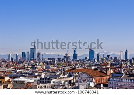 New panoramic skyline in Milan 2012. The picture was taken from the Duomo cathedral and shows the new buildings from the Garibaldi districts. The Alps, less than 50 miles away, are on the background.