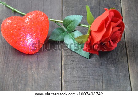 Red roses with hearts on a old wooden table, valentines day