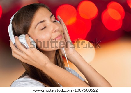 Portrait of a beautiful woman student  listening to music