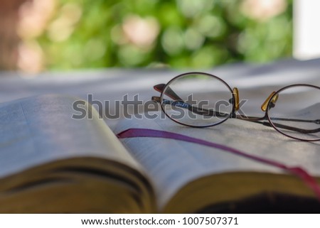 Glasses on bible page with room for text