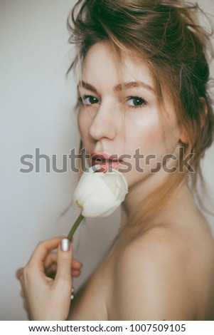 beautiful girl with a flower on a white background
